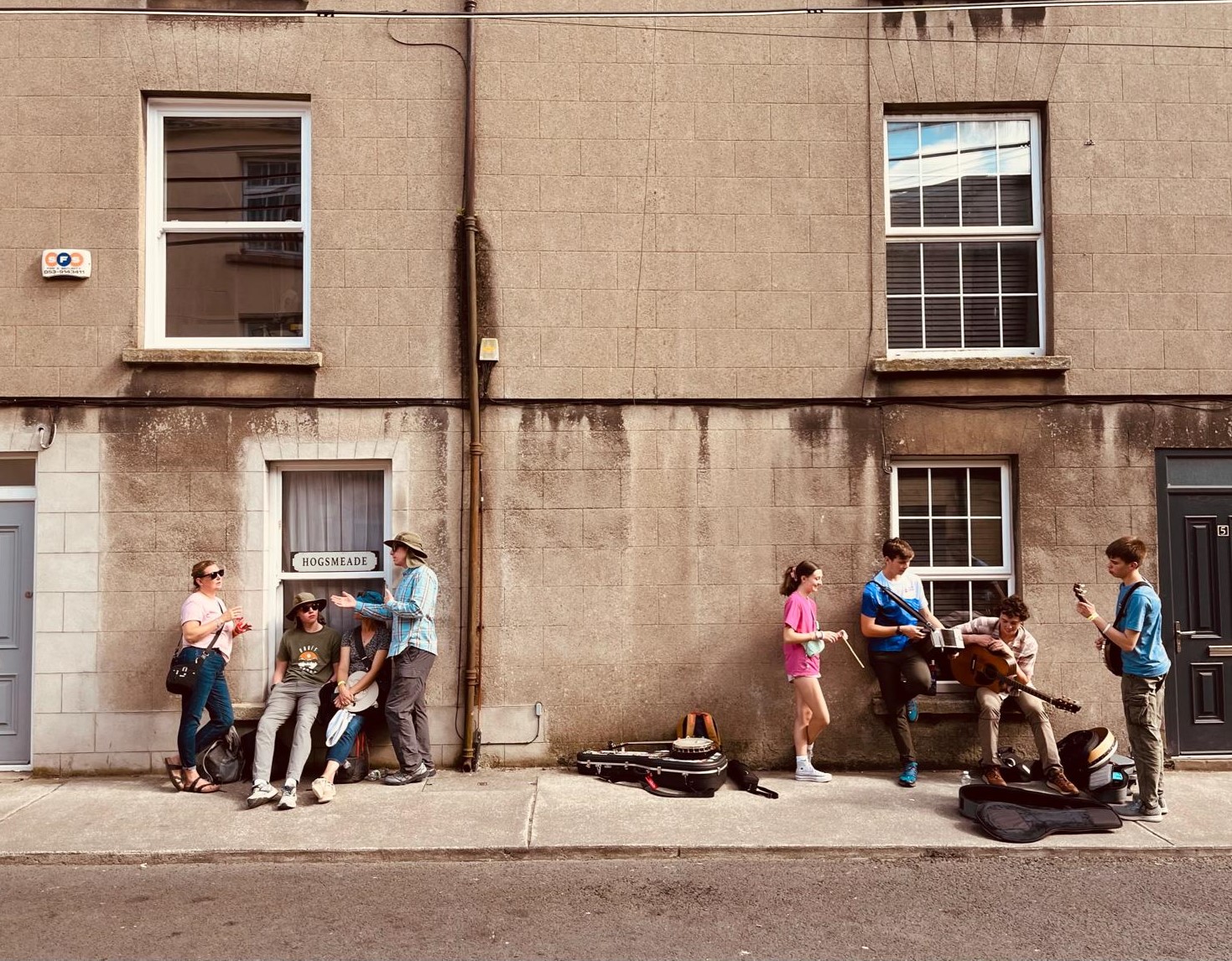 CIM families and buskers on a side street. From left: Galena Shirmer, James Fenton, Ruth Fenton, Simon Fenton, Ellie Shirmer, Teddy Brandt, Henry Brandt, Collin Fenton.