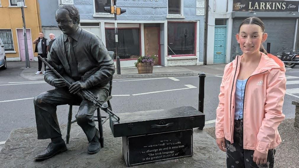 Katya and the iconic Willie Clancy statue, Miltown Malbay, County Clare, Ireland.