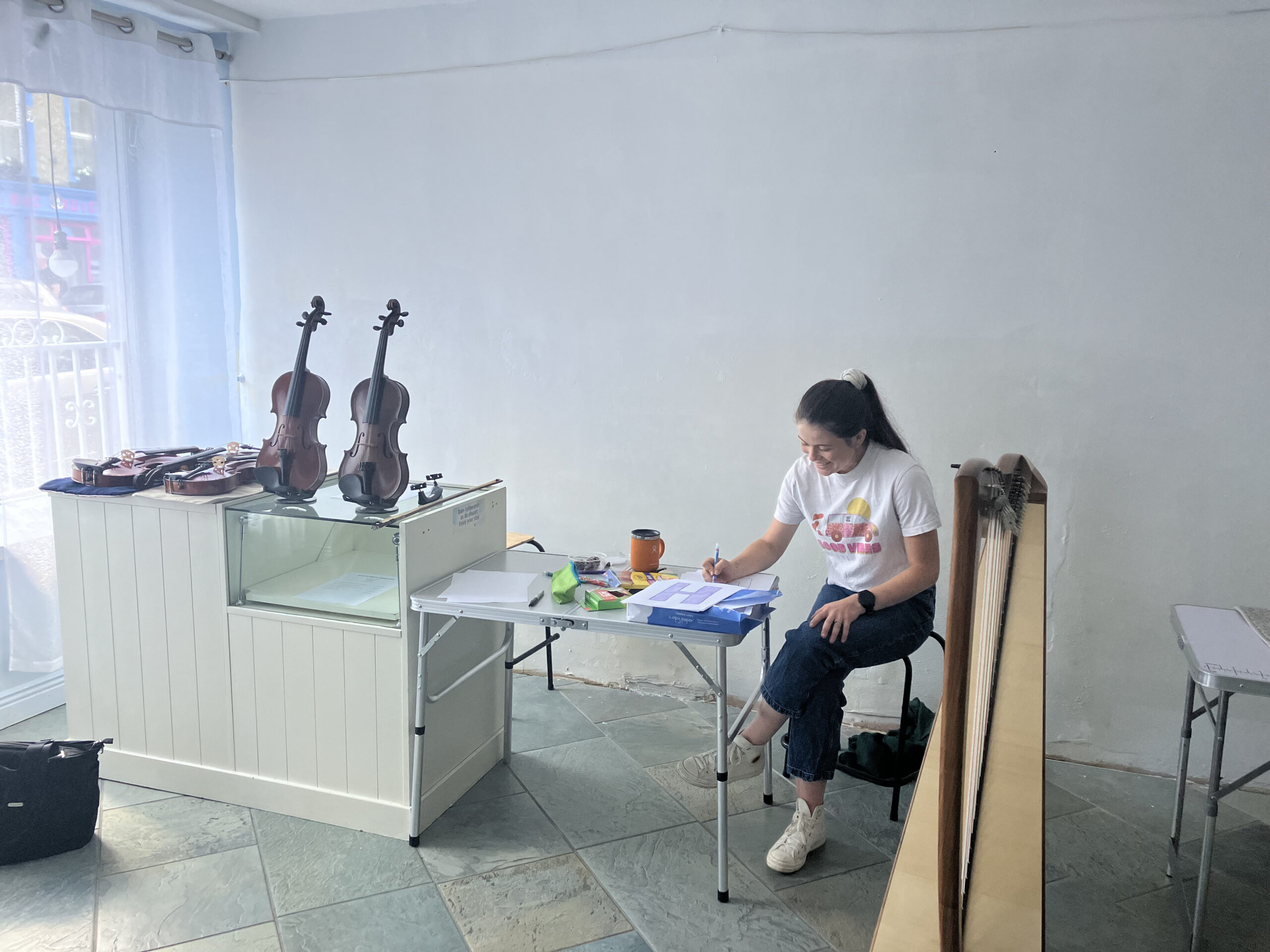 CIM alumnus Victoria Pierce (pictured) and her partner Macdara Ó Faoláin set up shop during the festival to showcase Macdara's hand-crafted bouzoukis. Photo courtesy of Dáithí Sproule