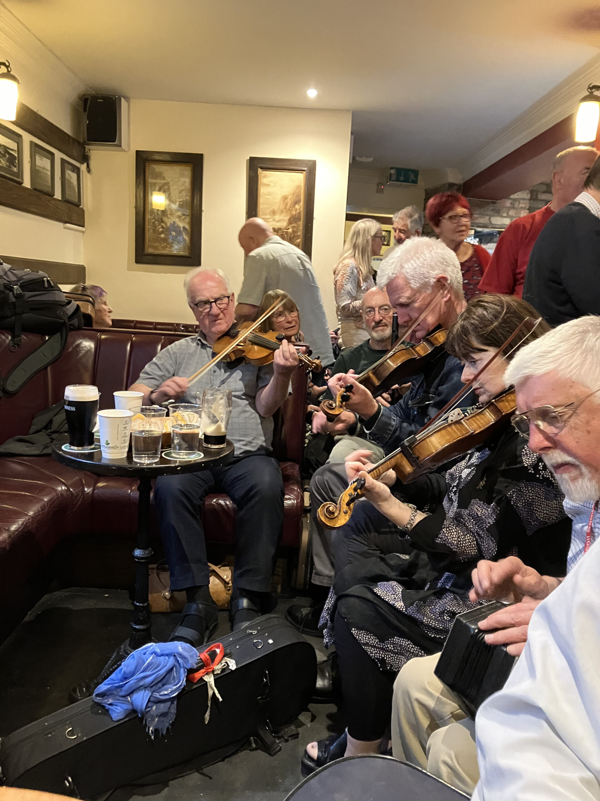 A session in Friel's with John Kelly Junior facing us (2010 Harvest Home visiting artist) and flute-player PJ Howell to his left. Both of these musicians frequented the old Four Seasons on Capel Street in Dublin, led by John Kelly Senior, with Dáithí Sproule, James Kelly and Paddy O'Brien and others. Fiddler Martin Dowling is playing fiddle in the center of the session. Photo courtesy of Dáithí Sproule