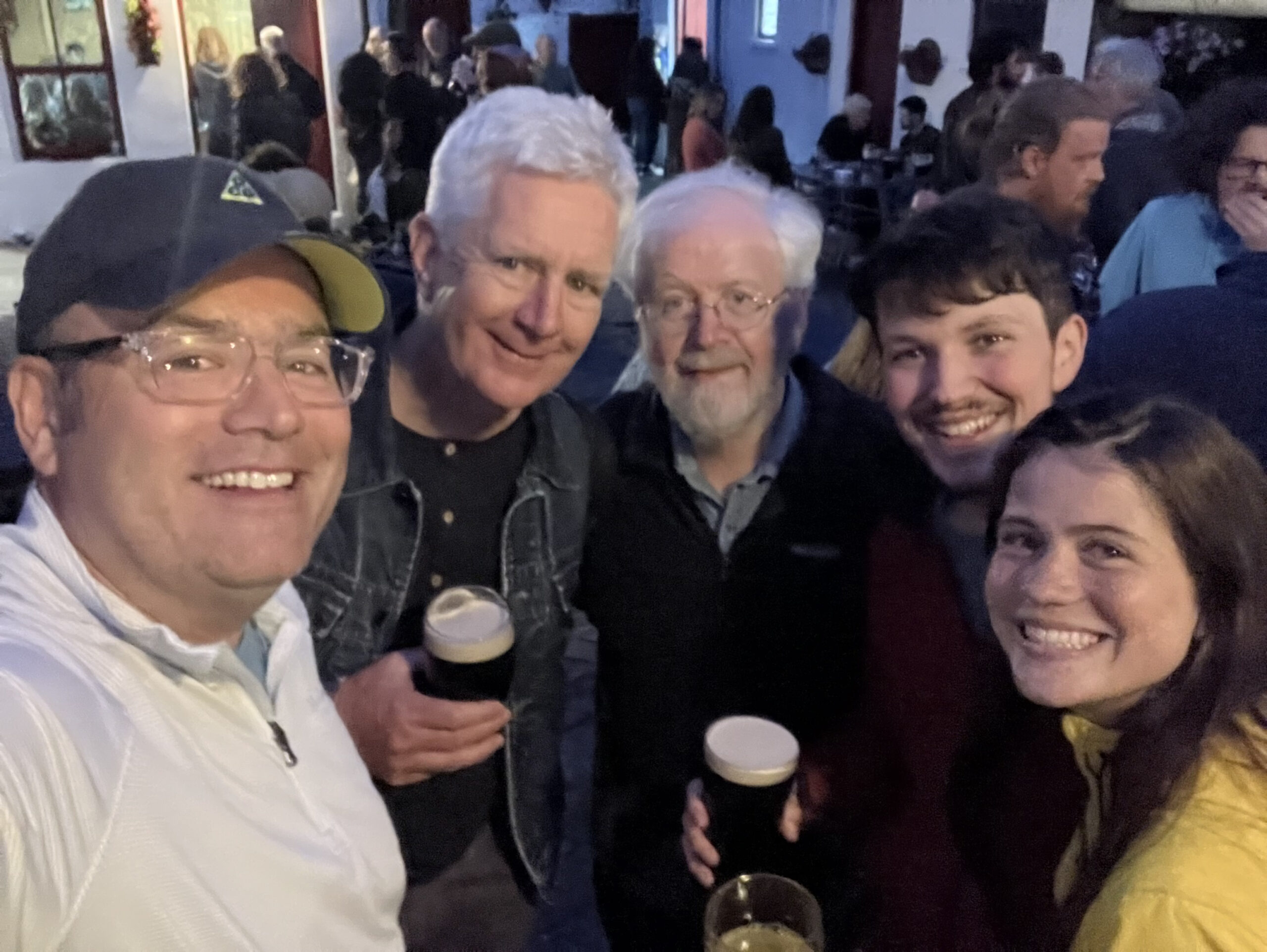 From left to right: Mike DeGeorgeo (whistle player and CIM alumnus parent of fiddler Joe DeGeorgeo who was off playing at session), Martin Dowling (fiddler, brother of CIM instructor Jode Dowling), Dáithí Sproule, Macdara Ó Faoláin, and Victoria Pierce catching up over a pint. Photo courtesy of Dáithí Sproule